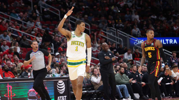 Rockets forward Jabari Smith Jr. (1) reacts to his three-point basket against Atlanta Hawks guard Dejounte Murray (5) in the third quarter at Toyota Center.
